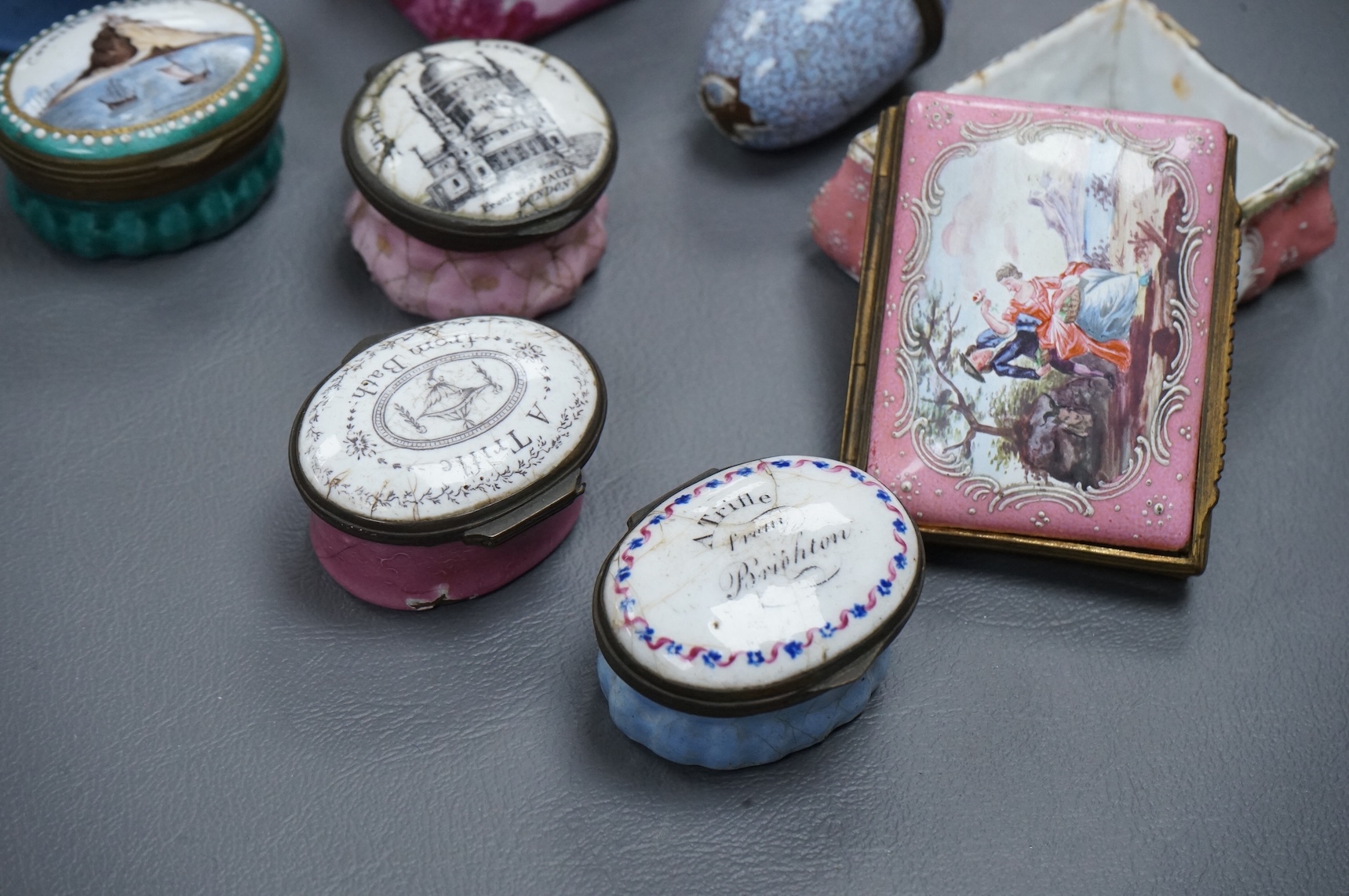 A collection of seven late 18th / early 19th century South Staffordshire enamel patch and snuff boxes and a continental porcelain snuff box, Largest 3.5cm high (8)